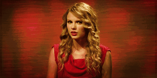 a woman in a red dress makes a funny face