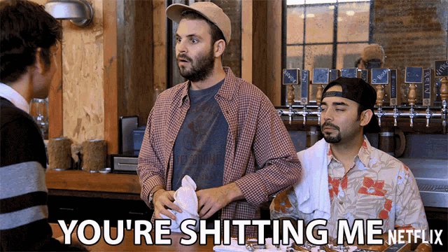 a man in a plaid shirt says " you 're shitting me netflix " in front of two other men