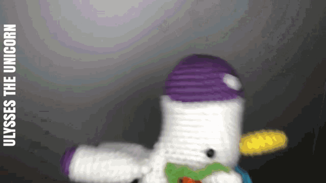 a stuffed unicorn with a purple hat and a yellow toothbrush