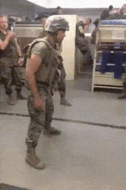 a man in a military uniform stands in a room