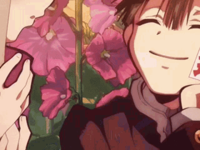 a close up of a person holding a piece of paper in front of a flower .