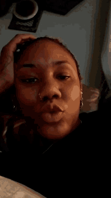 a woman with a nose ring is laying down