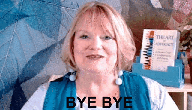 a woman in a blue shirt says bye bye