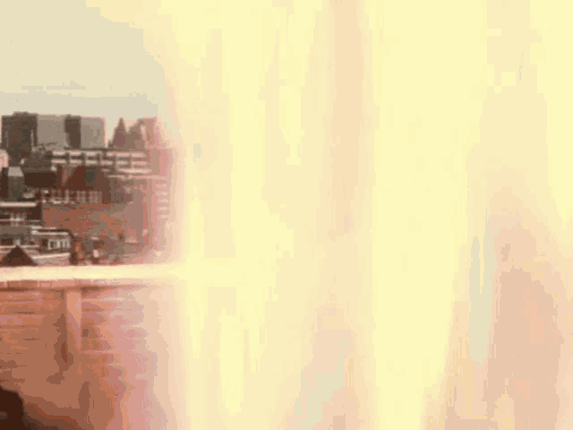 a blurred image of a city with a few buildings in the background