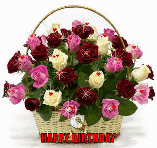 a bouquet of flowers in a basket with the words happy birthday on it