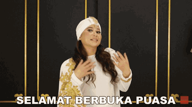 a woman wearing a white turban and a white shirt says selamat berbuka puasa