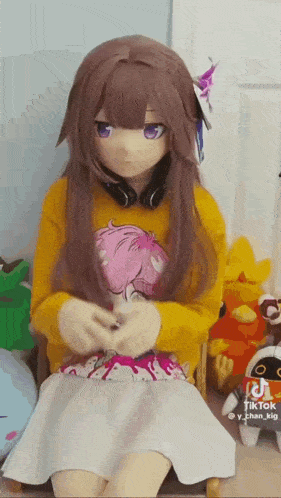 a girl in a costume is sitting on a chair .