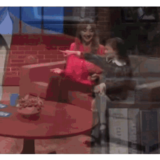 a woman and a child are sitting on a couch