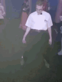 a blurry picture of a group of people dancing in a dark room