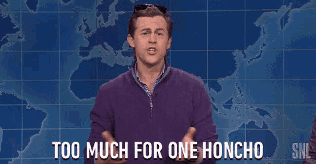 a man says too much for one honcho in front of a world map