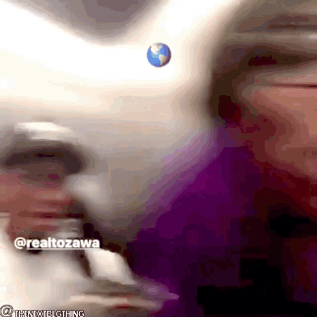 a blurry picture of a person with the name realtozawa on the bottom right