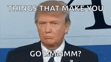donald trump is wearing a suit and tie and making a face .