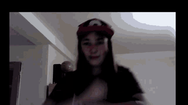 a girl is wearing a red hat with a pokemon on it