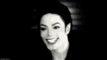 a close up of a man 's face smiling in a black and white photo .