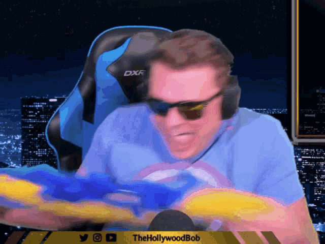 a man wearing sunglasses and headphones is playing a video game with the hollywoodbob written on the bottom