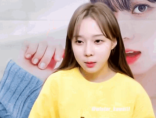 a woman wearing a yellow shirt with the words @wiator_kawaii written on it