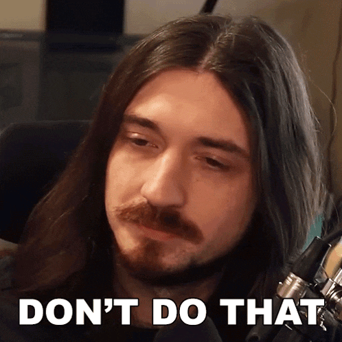 a man with long hair and a beard says " do n't do that " in front of a microphone