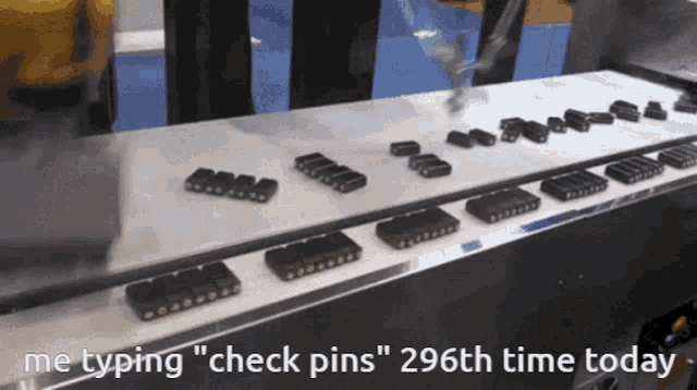 a conveyor belt with check pins on it and the words " me typing check pins " at the top