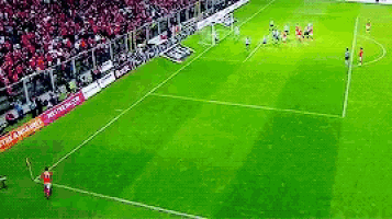 a soccer game is being played in a stadium with a banner that says arsenal on it