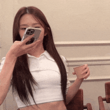 a woman holding a cup and a cell phone with a case that says casetify