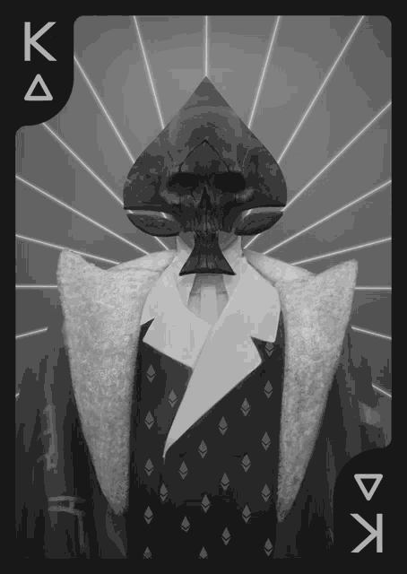 a black and white photo of a king spades card with a skull on it