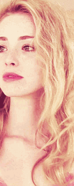 a close up of a woman 's face with freckles