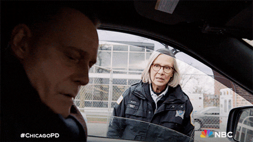 a woman in a police uniform is talking to a man in a car with #chicagopd