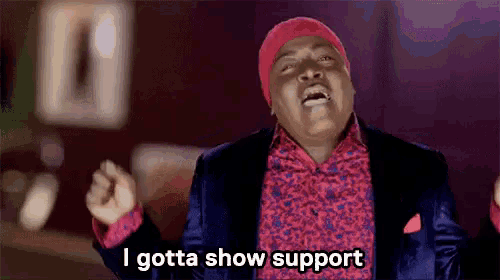 a man wearing a red hat and a suit says i gotta show support