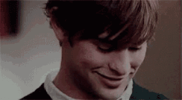 a close up of a young man 's face with a smile on his face .