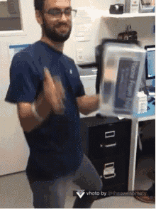 a man in a blue shirt is holding a plastic container that says ' hope health ' on it