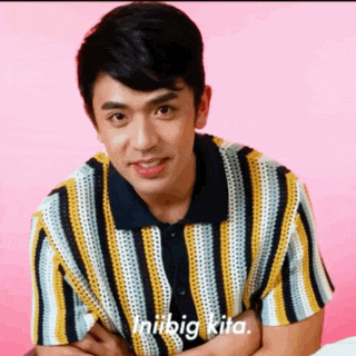 a man wearing a striped shirt with the words iniibig kita written on the bottom