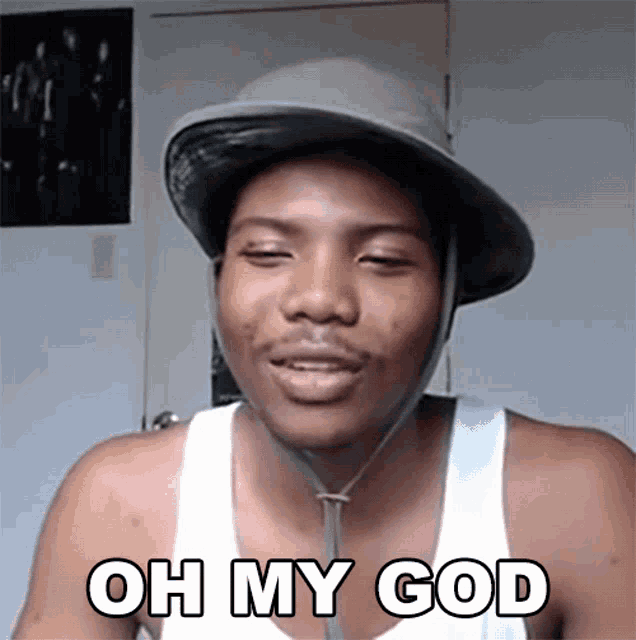 a man wearing a hat and a white tank top says " oh my god "