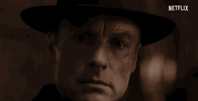 a close up of a man 's face with netflix written on the bottom
