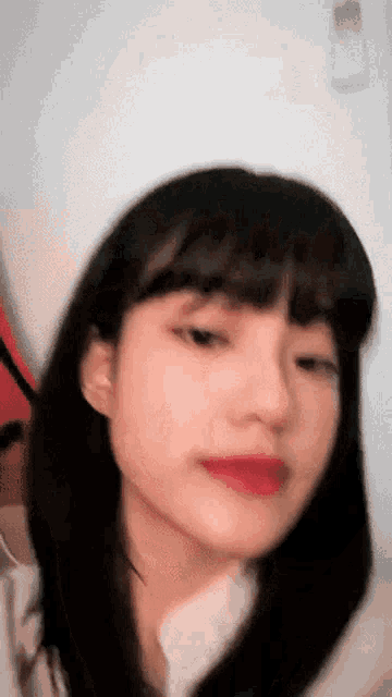 a close up of a woman 's face with a blurred background .