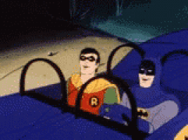 batman and robin are sitting in a blue car