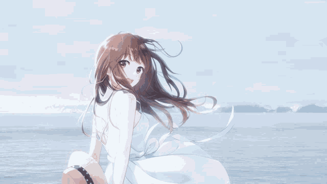 a girl in a white dress and a straw hat is sitting on the beach