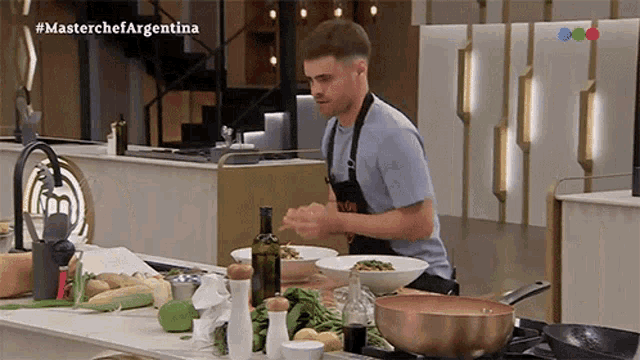 a man in an apron is preparing food in a kitchen with the hashtag #masterchefargentina