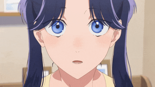 a close up of a girl 's face with a surprised look on her face
