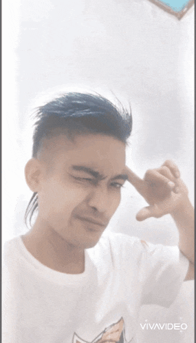 a man with blue hair is making a funny face with his hand on his forehead