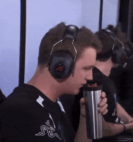 a man wearing headphones and a shirt with a snake on it