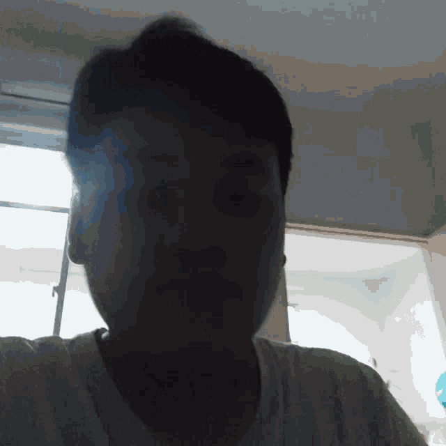 a man in a white shirt looks at the camera
