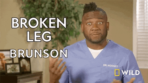 a man in a blue scrub is talking about a broken leg brunson