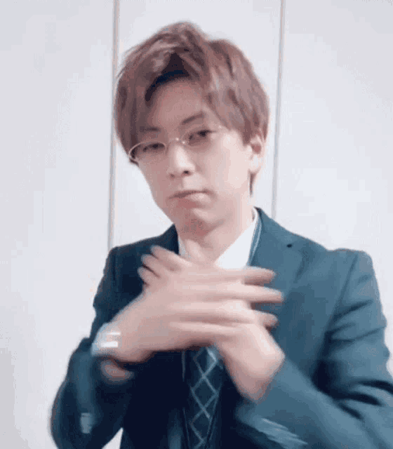 a man in a suit and tie is making a funny face .