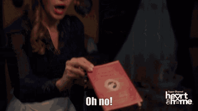 a person holding a book that says oh no on the bottom