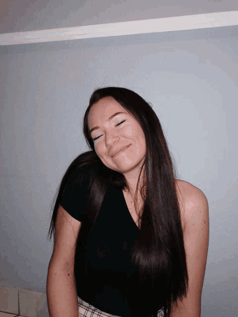 a woman with her eyes closed and a smile on her face