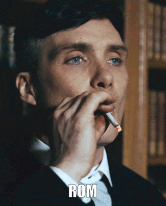 a man in a suit is smoking a cigarette and the word rom is on the bottom