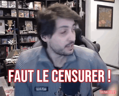 a man in front of a microphone with the words " faut le censurer " on the screen