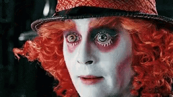 a close up of a person wearing a red hat and red wig .