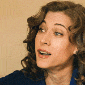 a close up of a woman 's face with a slight smile on her face