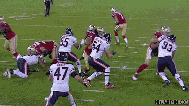 a football player with the number 54 on his jersey is being tackled by another player